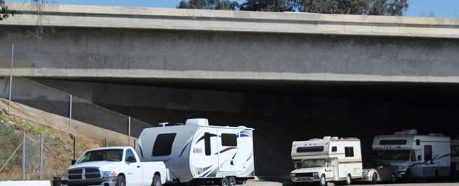 RVs parked under bridge