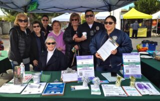 Melinda Porter (seated) Suzanne Lewis-Gregory, Alice Hart, Daryl Baskin, Sandy Benson, Carol Suarez, Officer Rob and Paola Posada
