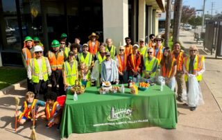 Group of people invest standing behind the Neighborhood Council Valley Village table at the Laurel Canyon cleanup
