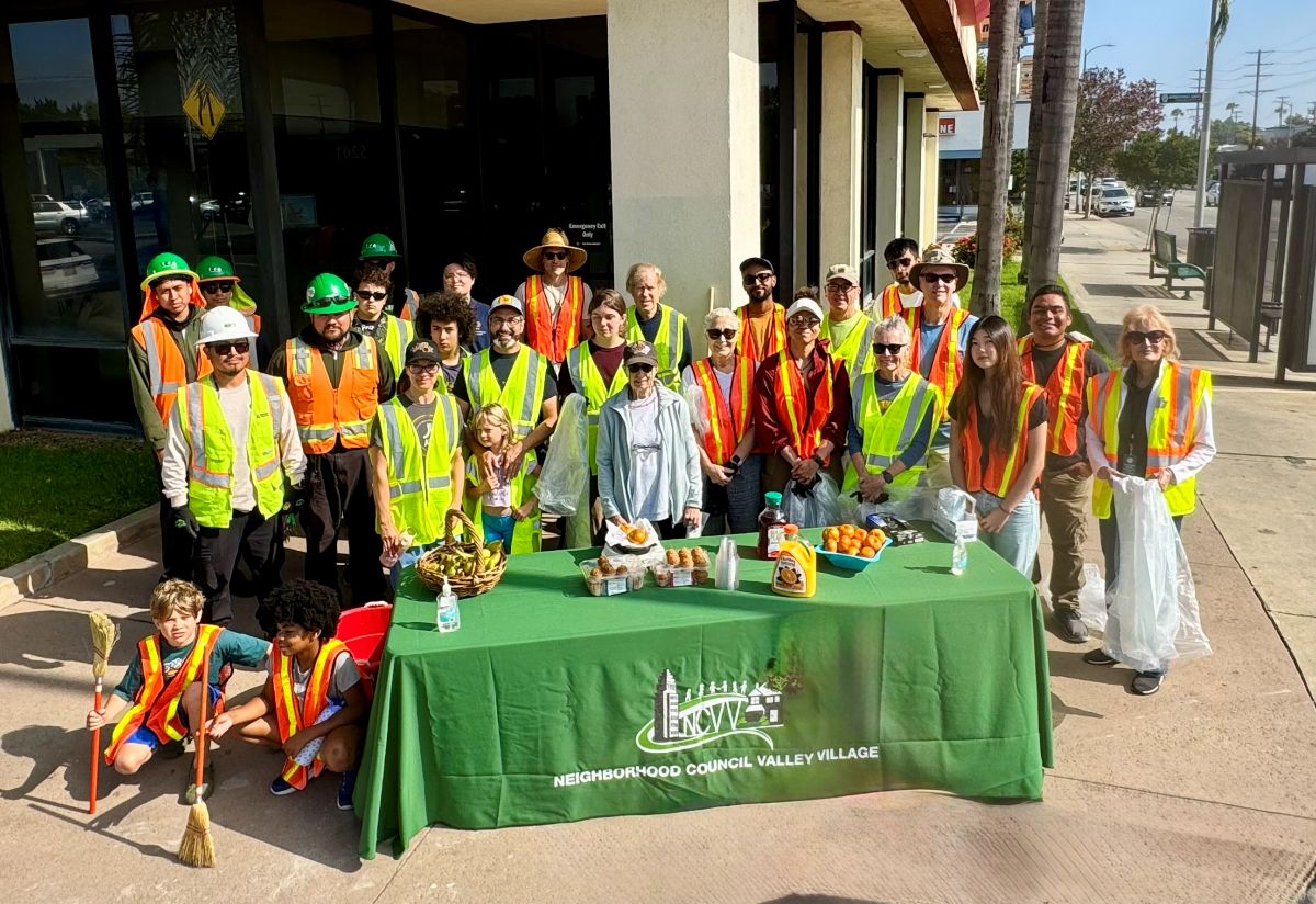 Laurel Cyn Clean Up 6-20-26 Group Shot 1200 Group of people invest standing behind the Neighborhood Council Valley Village table at the Laurel Canyon cleanup